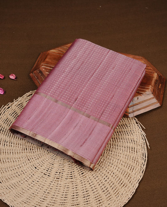 Mauve colour semi tussar silk saree featuring elegant gold zari dotted stripes across the body, enhanced with a rich zari woven border. Comes with a matching blouse piece.