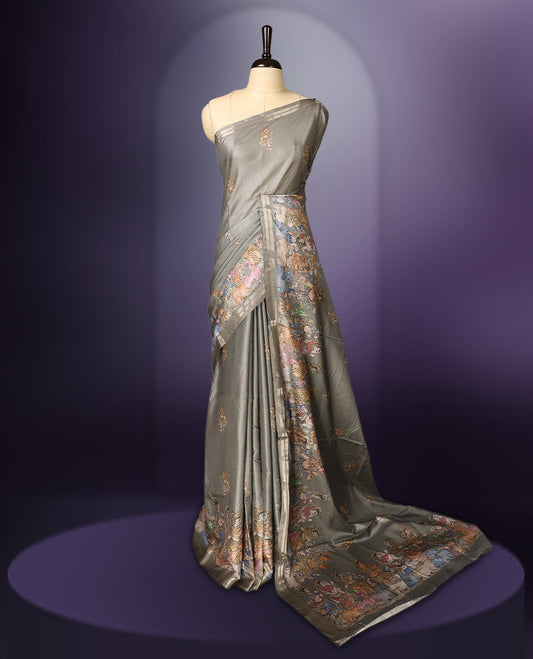 Grey saree adorned with delicate woven motifs across the body, accentuated by an intricately designed multicolour border, and a rich pallu featuring traditional artistic patterns, paired with a matching blouse.