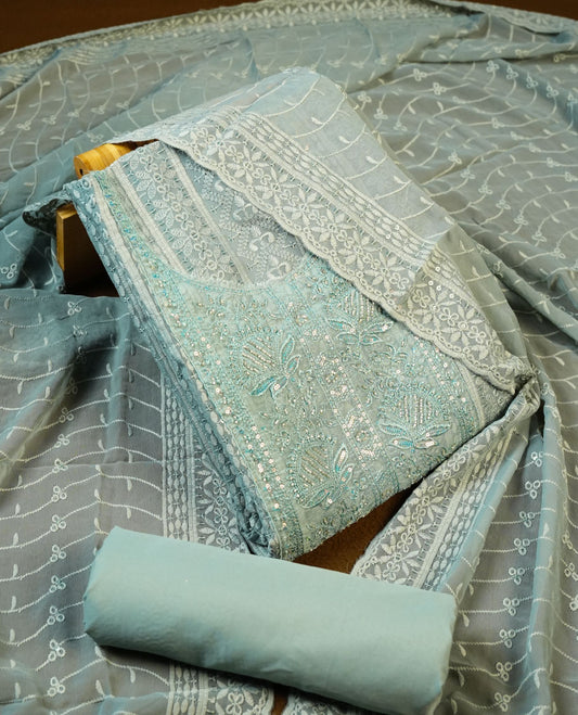 Soft Green colour Churidhar Material featuring Intricate Thread Embroidery with Mirror and Cut Beads Work on the Front Panel, paired with an All Over Embroidered Net Dupatta and Matching Bottom