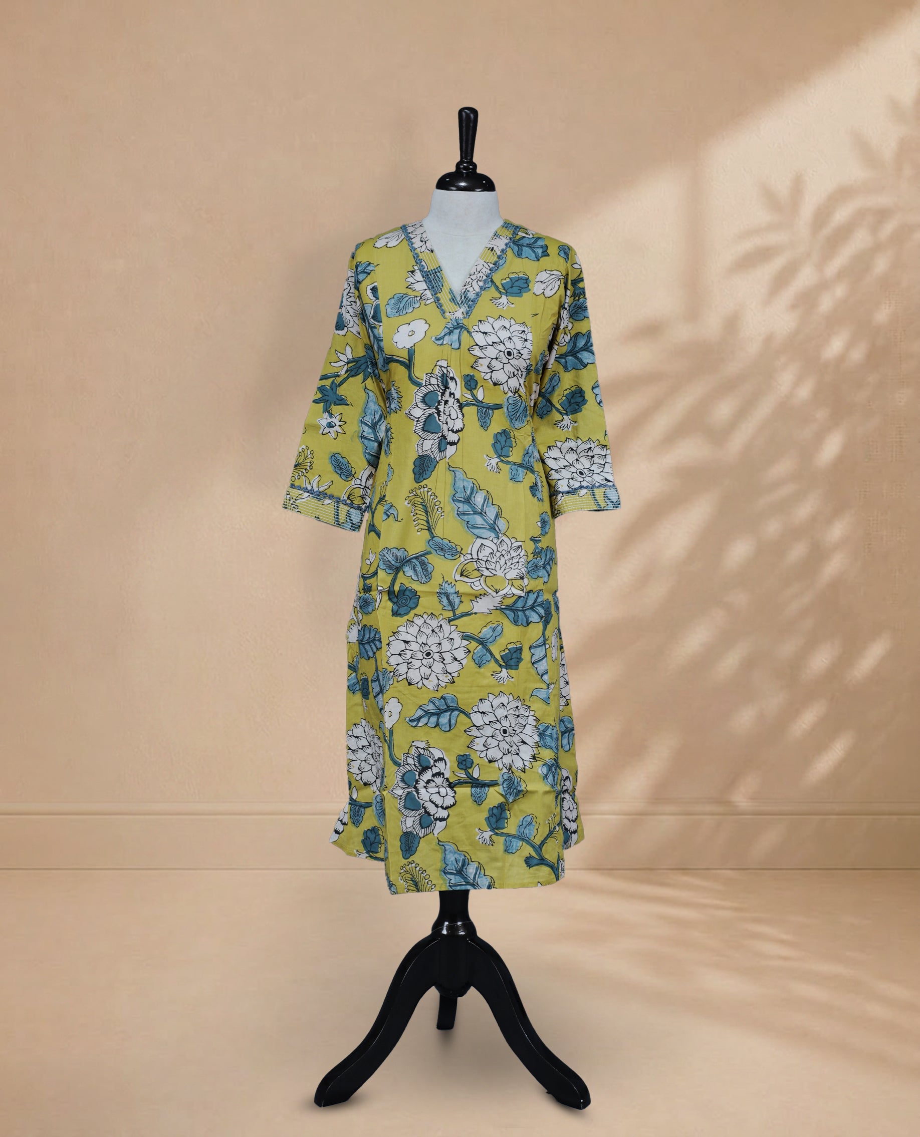 Dark Yellow kurti featuring a classic V-shaped neckline, intricate White & Teal Floral Prints on the body, and sleeves.