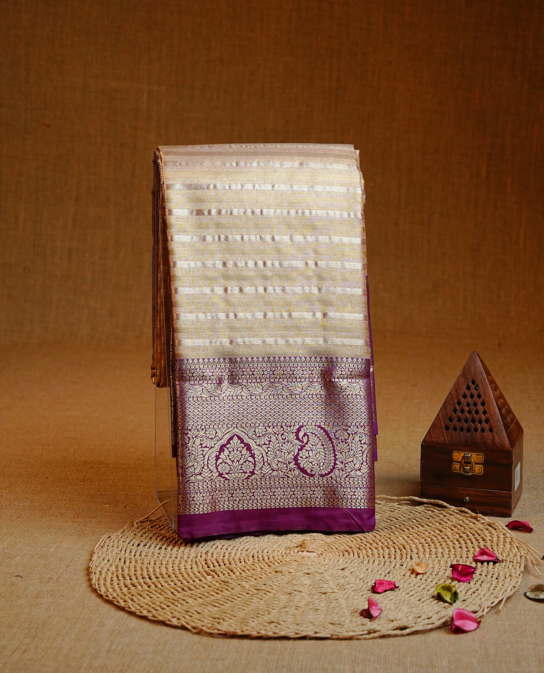 Golden colour Semi tissue silk saree featuring gold & silver Stripes on body, Contrast Purple colour with traditional border, paired with matching.