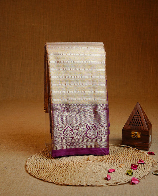 Golden colour Semi tissue silk saree featuring gold & silver Stripes on body, Contrast Purple colour with traditional border, paired with matching.