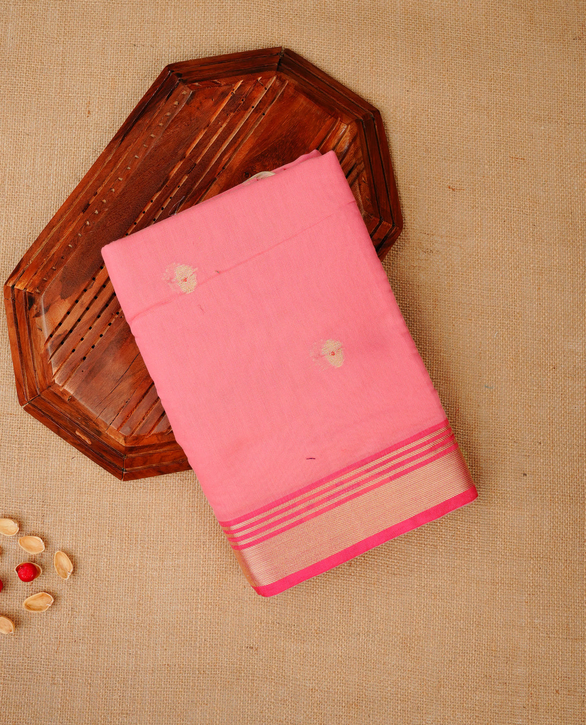 Bright peach colour Maheshwari cotton saree, gold zari floral motifs on body, complement light pink colour gold zari border comes with matching blouse.