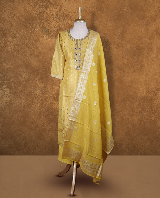 Yellow colour churidar set featuring thread and cut beats embroidered neckline, sleeves, and Gold colour motifs on body , Paired with a matching dupatta