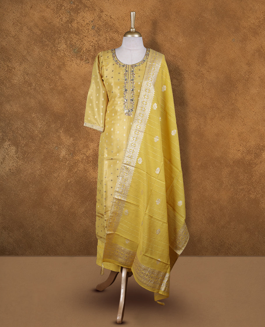 Yellow colour churidar set featuring thread and cut beats embroidered neckline, sleeves, and Gold colour motifs on body , Paired with a matching dupatta