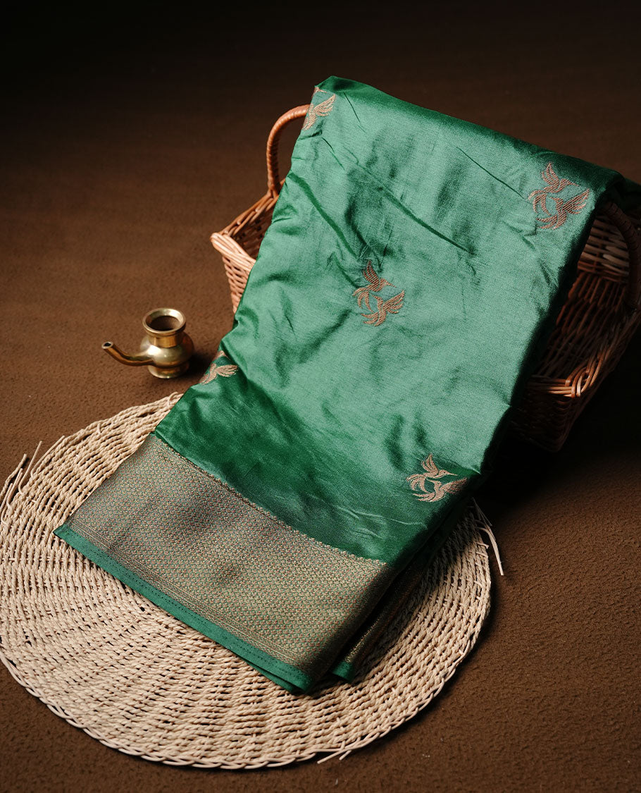 Green colour semi banaras tussar silk saree highlighting gold zari bird motifs on body, complemented by self colour with antique zari border, paired with matching blouse piece.