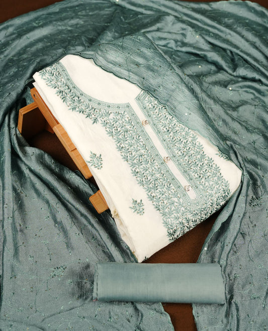 Ivory colour churidar material with teal colour thread embroidery on the front panel, paired with a matching dupatta and bottom.