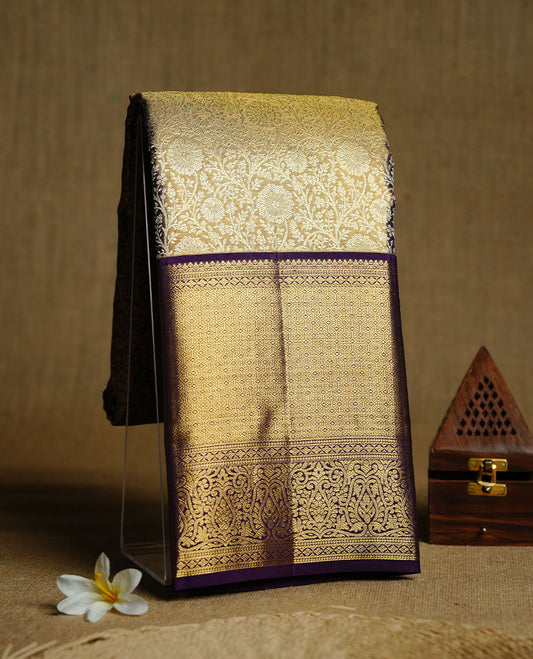 Gold colour kancheepuram tissue silk saree featuring gold zari pattern across body, complemented by contrast purple colour border traditional zari border, paired with matching blouse piece.