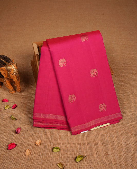 Pani Pink colour pure traditional Kancheepuram silk saree adorned with an elegant zari elephant motif on the body, complemented by a simple gold zari woven border paired with a matching blouse piece.
