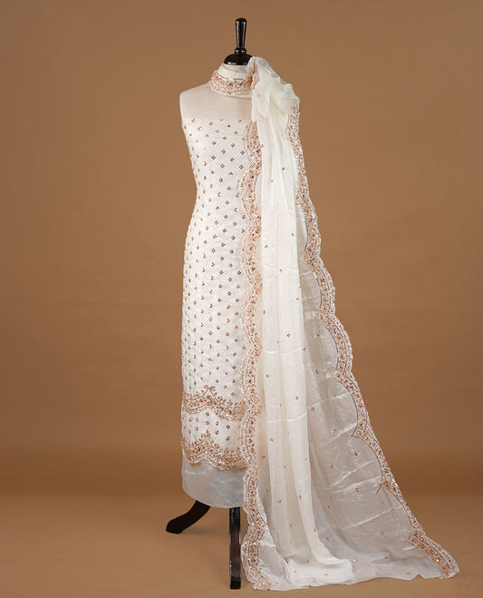 Off white colour churidhar material featuring cut beads and sequins work on the body, paired with a matching unstitched bottom and worked dupatta.