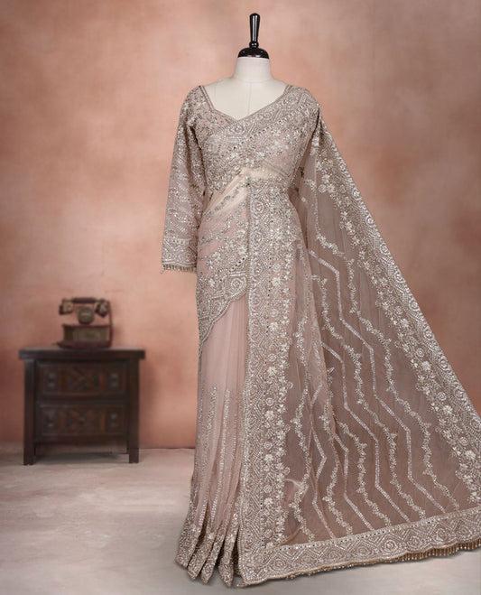 Beige Colour net designer Wedding saree featuring all over floral embroidery with sequin detailing and an ornate scalloped border, finished with a matching embellished blouse.