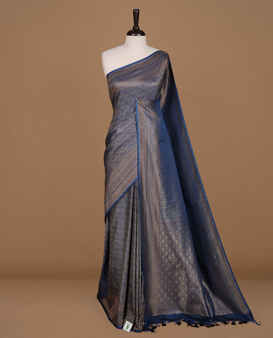 Teal colour semi banaras katan saree featuring Gold zari Pattern across body, complemented by self colour with zari border, paired with matching blouse piece.