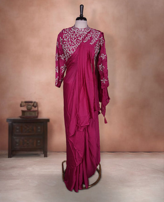 Rani pink colour ready to wear saree Fearturing intricate silver embroidery on the pallu, paired with a beats and thread embroidered matching blouse.
