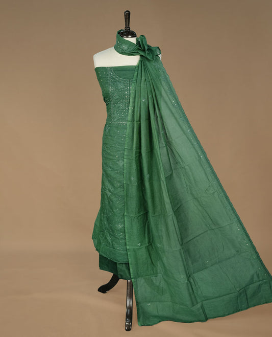 Green colour churidhar material featuring self colour thread and sequins work on body, paired with matching bottom and Dupatta.