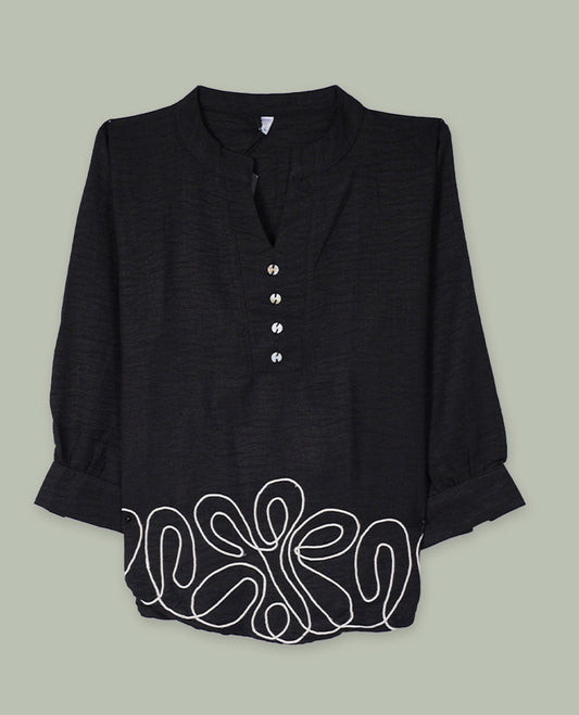 Black three-quarter sleeve tunic top with band collar, half button placket, and contrast white abstract cord embroidery along the hem.