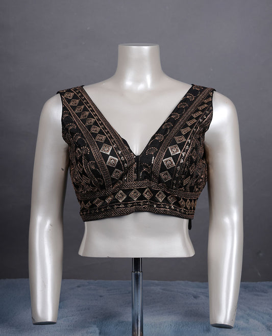 Black colour embroidered sleeveless blouse with intricate geometric motifs, deep V neckline, and tie-up back detailing for a chic finish.