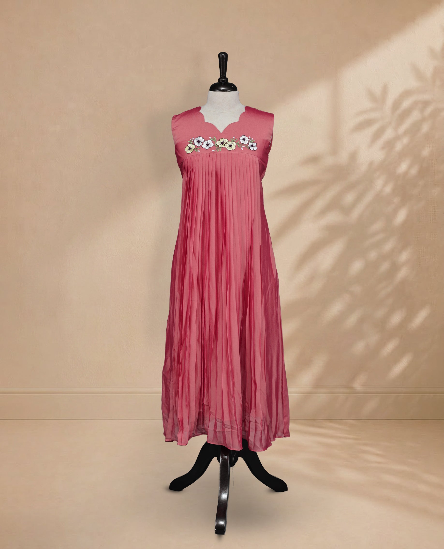 Peach Coloured Sleeveless Kurti Featuring a Designed Neckline, Floral Embroidery on the Body