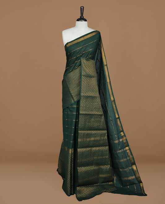 Green colour Sungudi cotton saree featuring Gold zari Stripes on body, Gold Small check zari on Self colour border, paired with matching blouse piece.