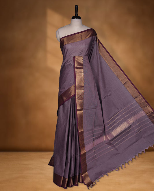 Lilac colour chettinad cotton saree featuring Elegant plain body highlighting contrast Maroon colour with gold zari traditional border, pallu and paired with matching blouse piece.