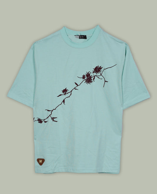 Sky blue colour T shirt featuring intricate wine coloured embroidery on the front and back, designed with a classic round neck and short sleeves & it offers a stylish and comfortable everyday look.
