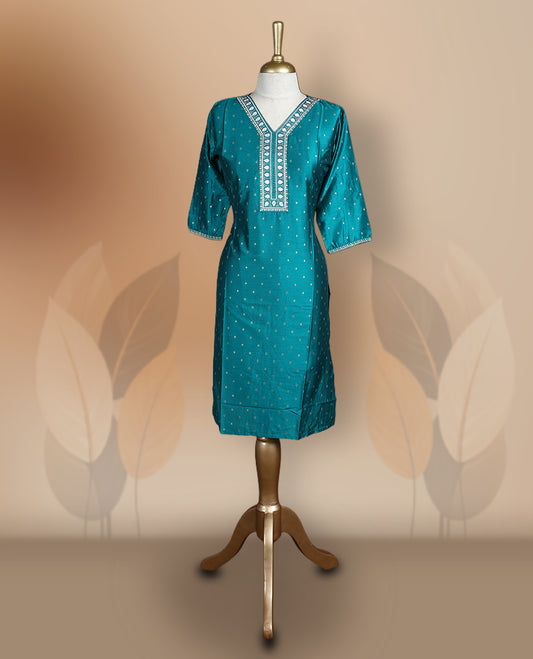 Peacock green colour kurti with delicate white embroidery and golden work on the neckline and sleeves, Features a stylish V-neck and 3/4th sleeves & ideal for casual outings or festive occasions.