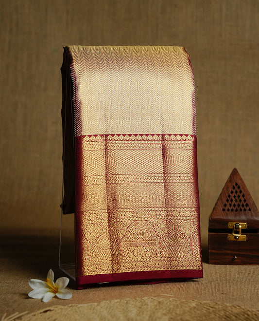 Gold & Maroon double shade colour kancheepuram tissue silk saree featuring gold zari stripeson pattern on body, complemented by contrast maroon colour with traditional border, paired with matching blouse piece.