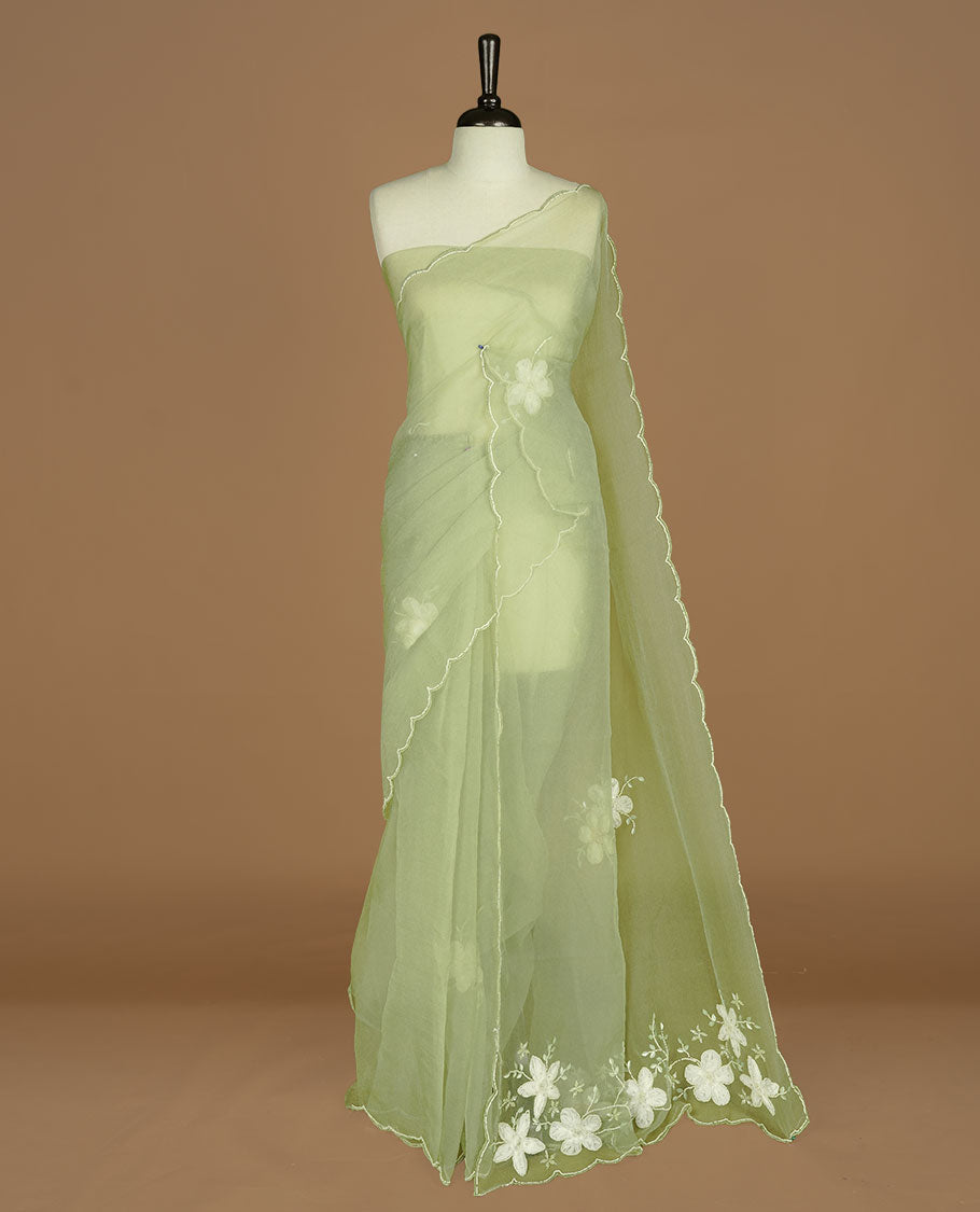 Pastel olive colour crush organza saree featuring white floral work with beats & sequins, highlighting scalp with beats worked border, paired with matching blouse piece.