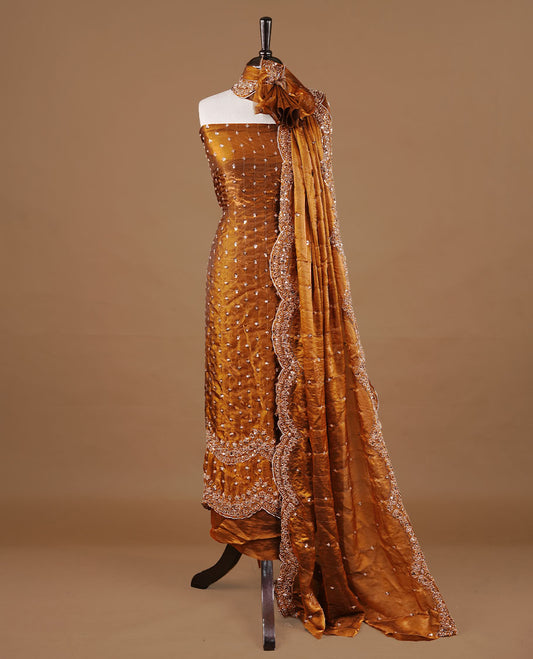 Brown colour churidhar material featuring cut beads and sequins work on the body, paired with a matching unstitched bottom and worked dupatta.