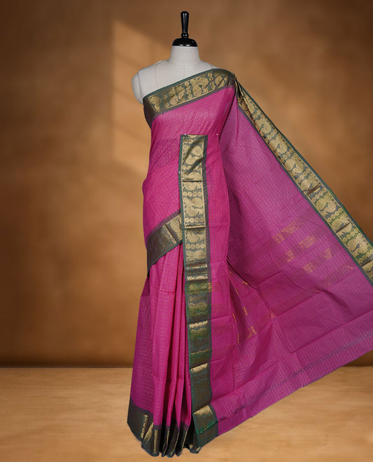 Magenta colour sungudi cotton saree featuring gold zari check pattern across body, contrast green colour with gold zari peacock and floral pattern on border, without blouse piece.