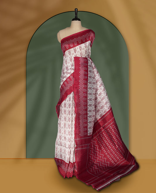 Classic off white colour saree adorned with intricate maroon tribal motifs and rich woven patterns on the pallu and border & Paired with matching blouse.