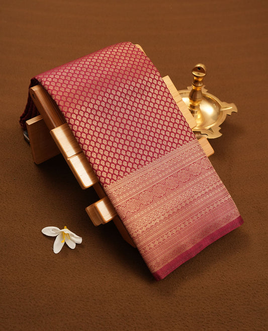 Chocolate brown colour semi silk brocade saree featuring intricate Gold patterns across the body, complemented by a Self colour woven border and pallu, paired with a matching blouse.