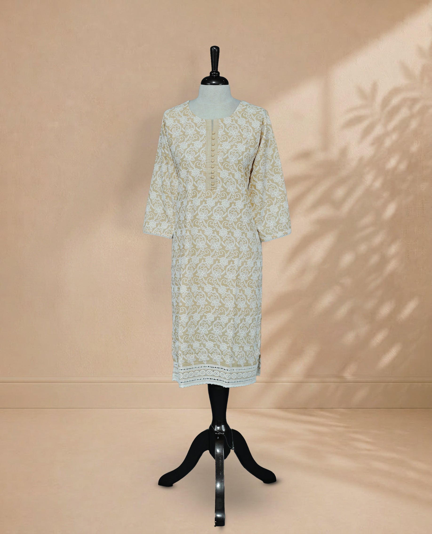 Light Orange Colour kurti featuring a classic U-shaped neckline, White Floral Embroidery Work on the body, and sleeves.