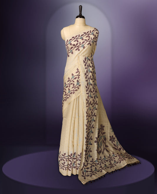 off white colour Kota net saree featuring a delicate floral kodi border with a plain body, paired with a matching blouse.