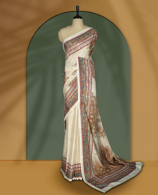 Off white colour saree with subtle polka dots, adorned with ornate multicolored borders and a traditional paisley pallu & Paired with a matching blouse.
