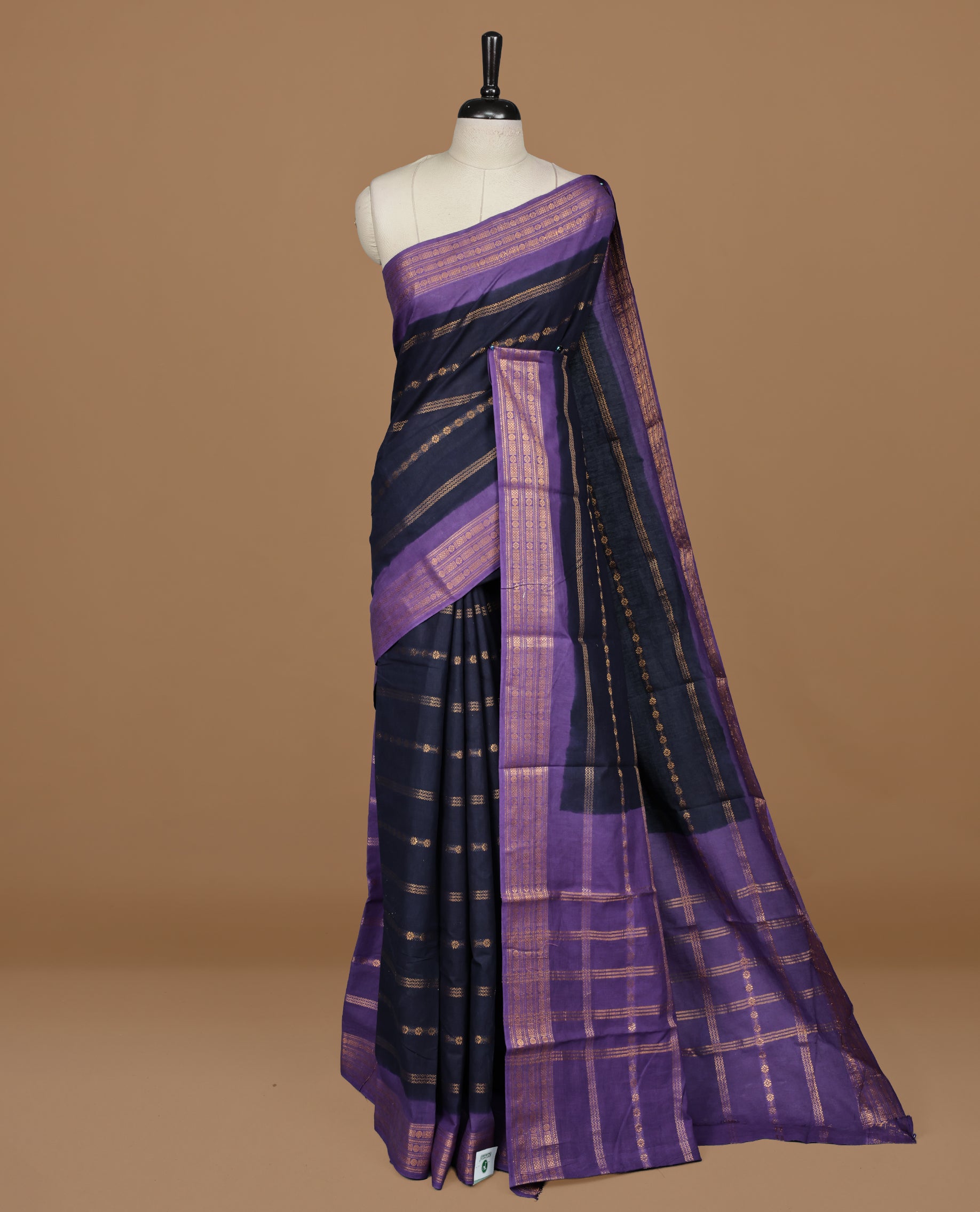 Navy Blue colour Sungudi cotton saree featuring Gold zari Stripes on body, Gold zari on Contrast Purple colour border, paired with matching blouse piece.