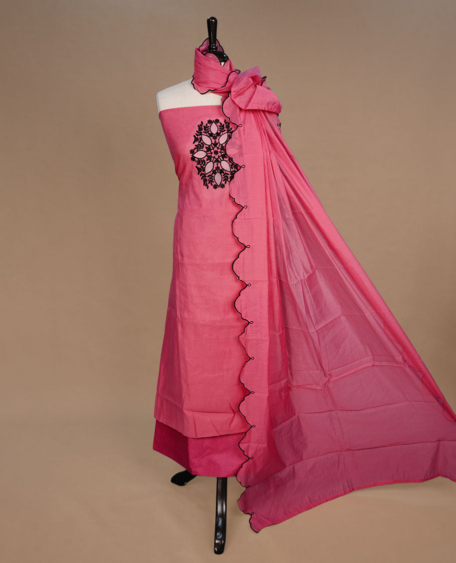 Pink colour churidari material featuring black thread pattern on body, paired with matching bottom and dupatta.