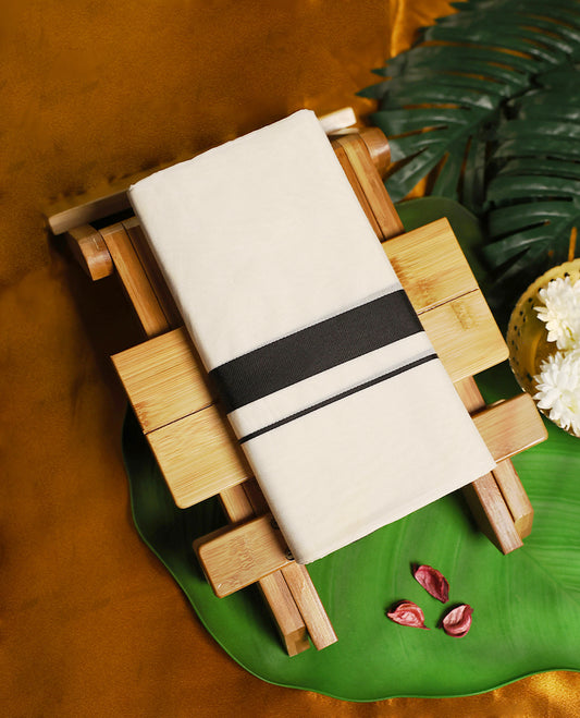 Traditional off white colour pure cotton dhoti featuring a bold black border, combining simplicity with a contemporary touch, making it a perfect choice for temple visits, cultural functions, and festive occasions.