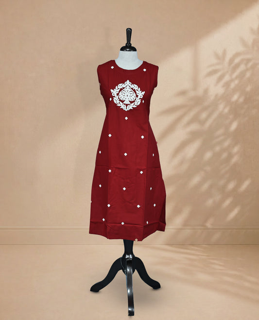 Rust Orange Kurti featuring threadwork across the body, a round neckline with threadwork on the yoke, and a sleeveless design.