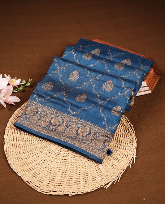 Crystal Teal colour semi Banaras saree with gold zari buta motifs, finished with a traditional gold zari border and pallu, paired with a matching blouse.