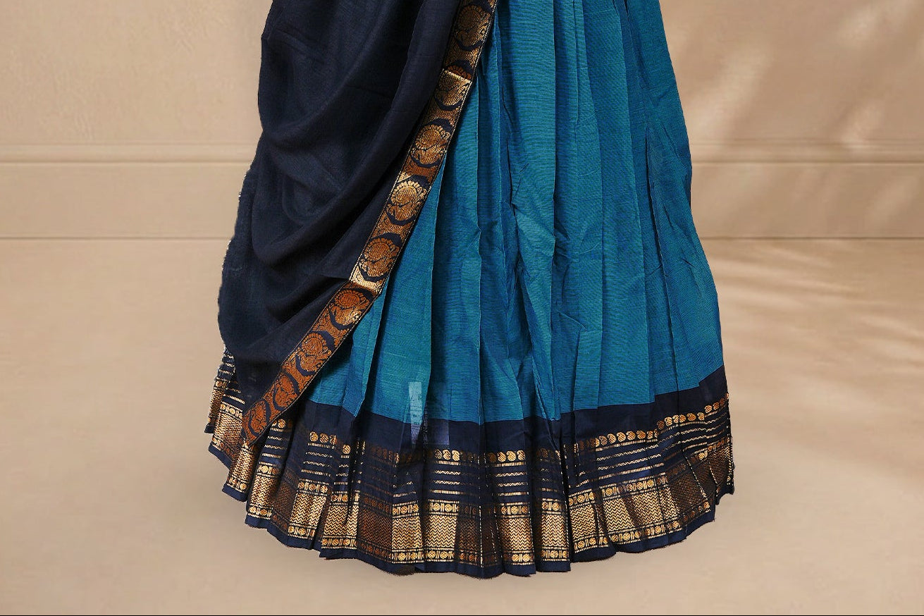 Teal colour Half saree featuring Plain skirt with Zari border on contrast black colour border, Unstitched Blouse and matching dupatta.