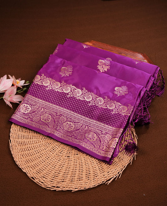 Grape purple  colour Banaras Satin Crepe saree featuring gold zari floral motifs on the body, a richly woven traditional border with intricate gold zari detailing, and paired with a matching blouse. (Copy)