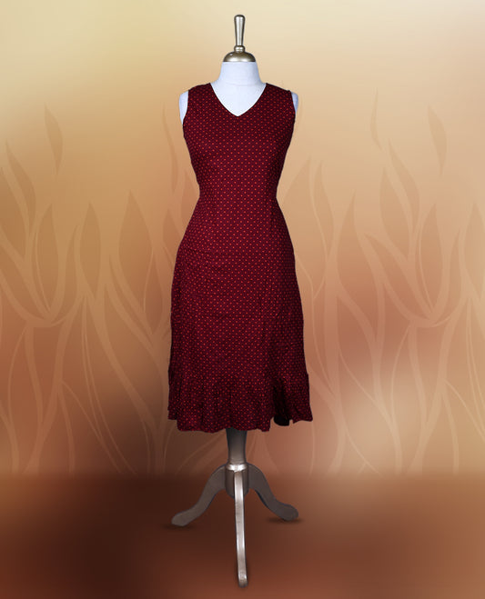 Dark maroon colour nightwear with orange colour polka dots, V neckline, and flutter sleeves & The flared hem with pleats adds a chic touch, Ideal for casual wear, office looks, or relaxed outings with a stylish twist.