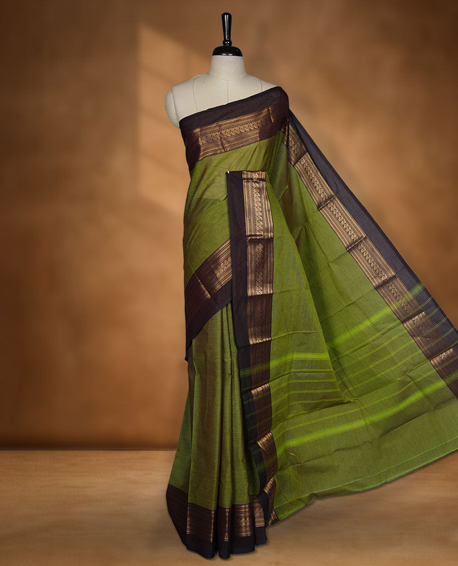 Olive green colour chettinad cotton saree featuring plain body, contrast Dark Brown colour with traditional gold zari border without blouse.