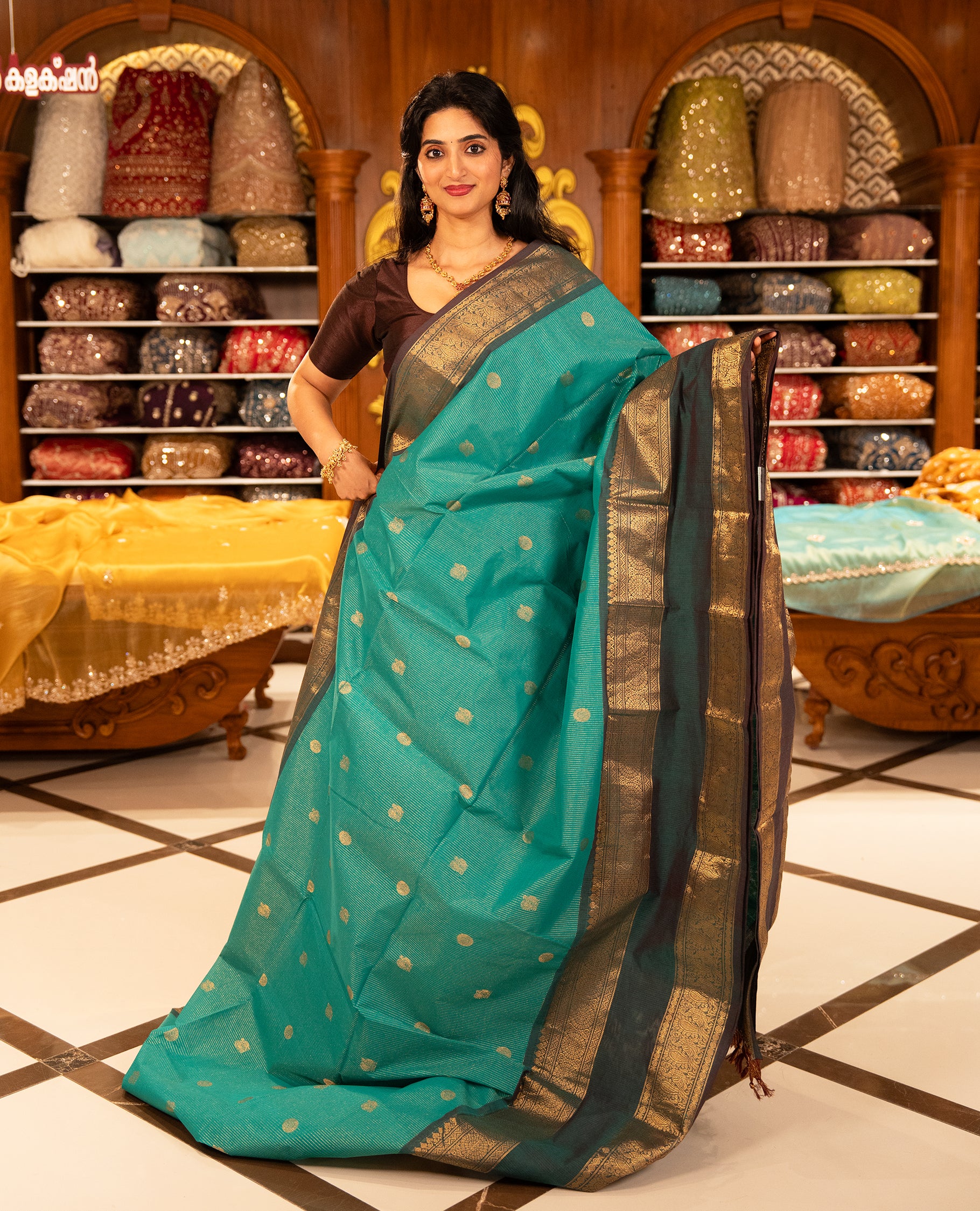 Aqua with Brown colour Chettinad cotton saree featuring Gold zari strips with peacock motifs on body, complemented by contrast colour border with zari design & grand pallu, comes with matching blouse piece.