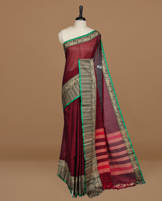 Maroon colour Narayanapett cotton saree Featuring Elegant plain Body, complemented by Contrast Black colour with cream zari border, paired with matching blouse piece.