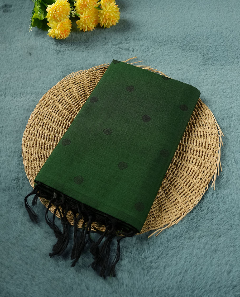 Dark green colour poly cotton saree with black abstract butti motifs on the body, paired with a matching pallu with dense black textured round butta pattern, and a coordinated all‑over textured round butta printed blouse piece.