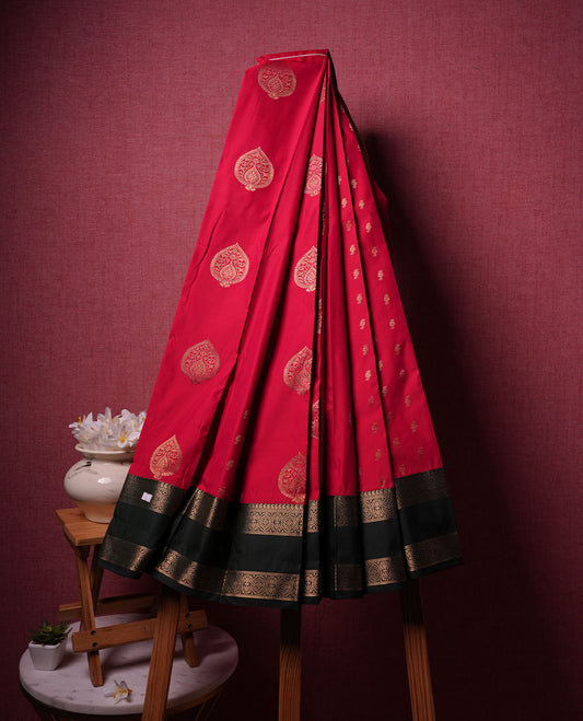 Red colour semi silk saree highlighting gold zari check motifs across body, featuring contrast Dark green colour border with gold zari pattern, comes with matching blouse .