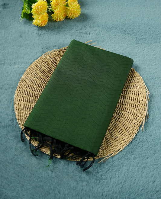 Dark green colour poly cotton saree with black zigzag line pattern on the body, paired with a matching pallu featuring black chevron lines and panelled floral‑paisley design, and a coordinated all‑over floral paisley patch‑style printed blouse piece.