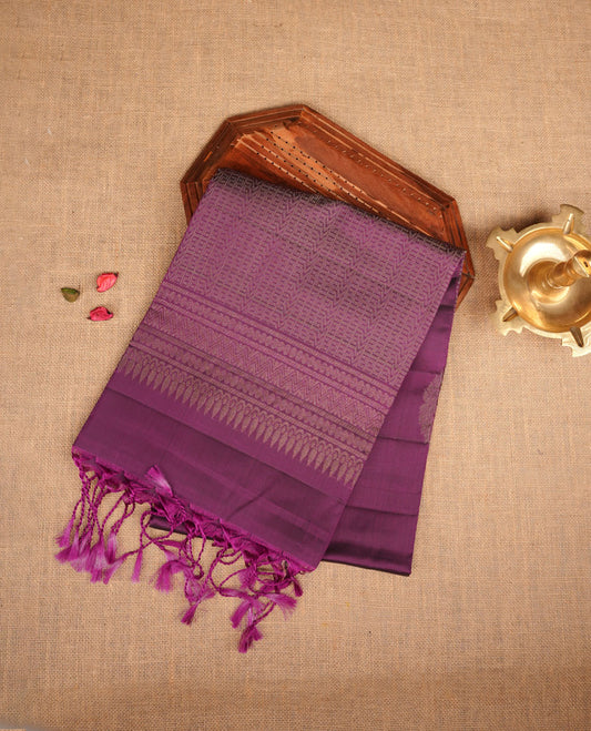 Purple colour soft silk saree featuring gold zari motifs on body, complemented by self colour with traditional  border with tassel at pallu, paired with matching blouse piece.
