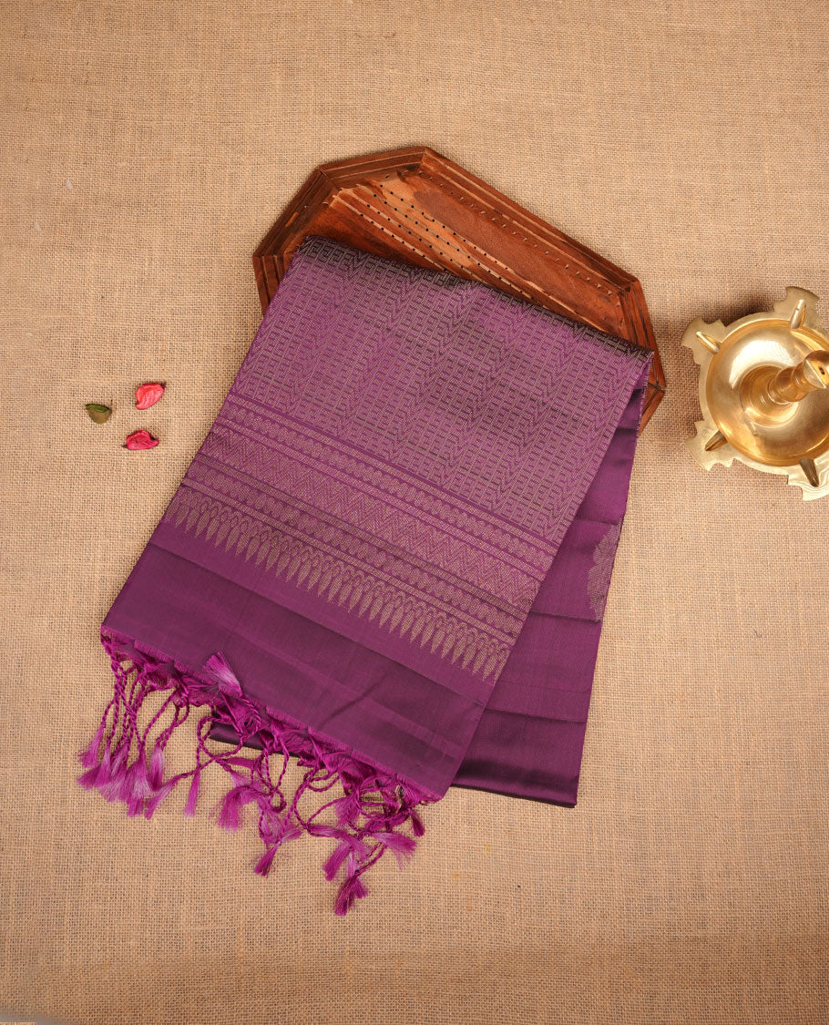 Purple colour soft silk saree featuring gold zari motifs on body, complemented by self colour with traditional  border with tassel at pallu, paired with matching blouse piece.